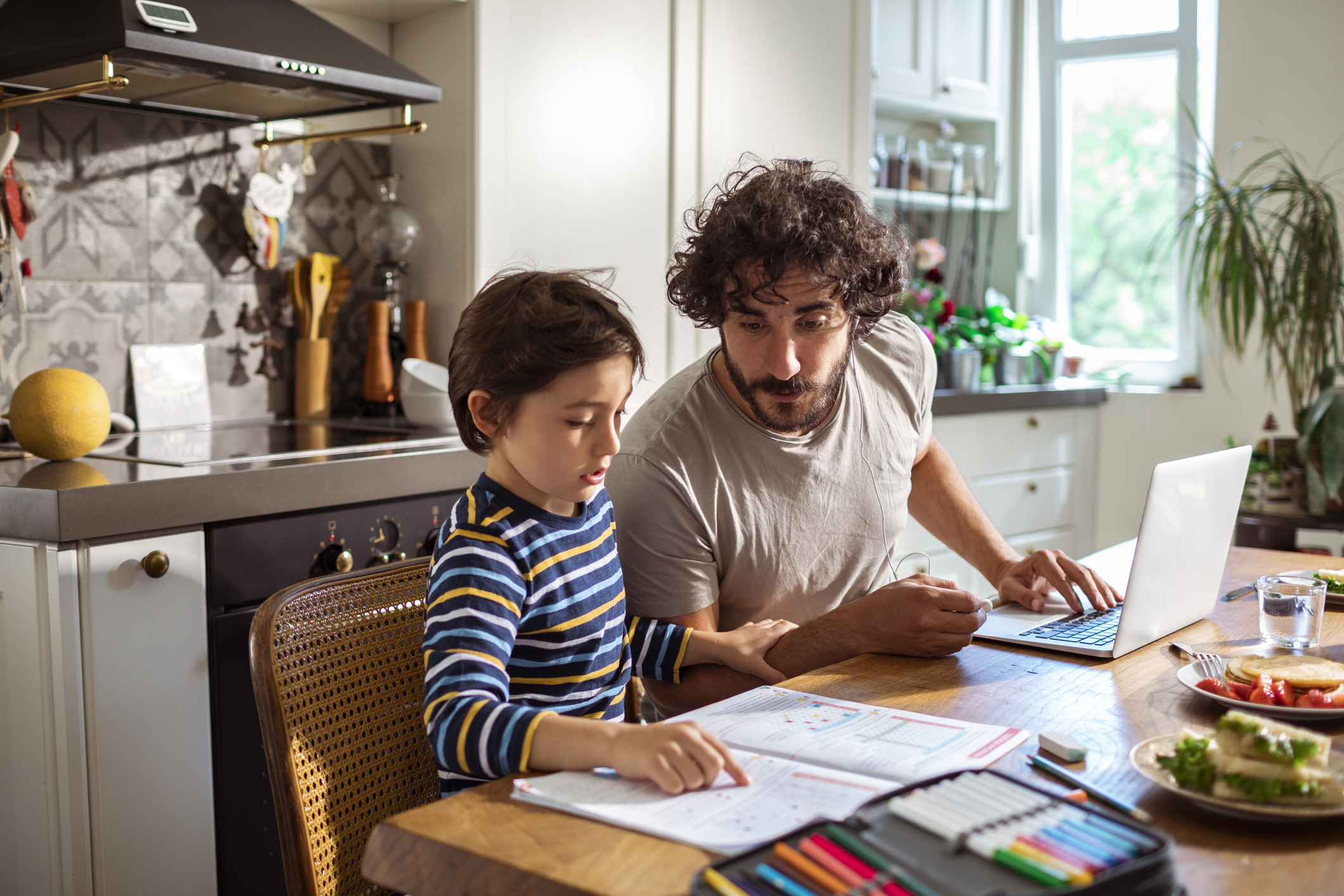 Father helping his son with schoolwork